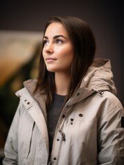 Portrait of a beautiful young woman in a winter jacket looking away