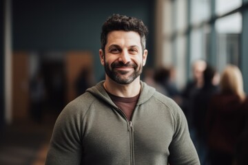 Fototapeta premium Portrait of handsome man smiling at camera while standing in conference hall