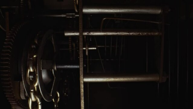 The mechanism inside the tower clock with a pendulum.