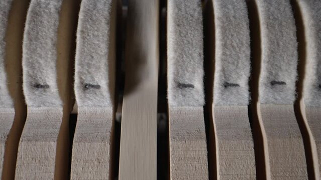 Inside the piano. Close-up view of hammers and strings inside the upright piano.