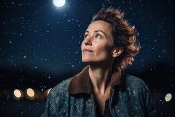 Portrait of a beautiful woman on the street at night with moon