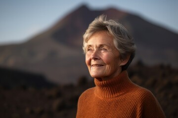 Fototapeta na wymiar Medium shot portrait photography of a pleased woman in her 60s wearing a cozy sweater against a volcano or lava background. Generative AI