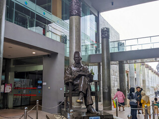 Bung Karno statue sitting holding a book in the Bung Karno library
