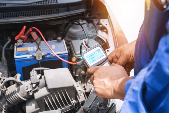 A multimeter voltmeter is used by auto mechanics to measure the voltage of a car battery.