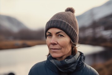 Portrait of a middle-aged woman on the background of the lake.