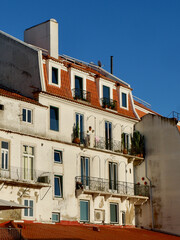 Fototapeta na wymiar Vintage shabby buildings downtown at sunset Lisbon, Alfama district, Portugal. Vertical photo