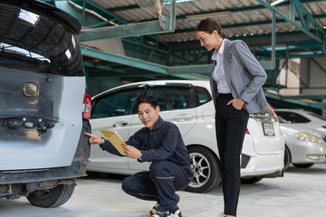 Asian car mechanic man in uniform explaining checklist car maintenance and repair to woman client at auto car garage service