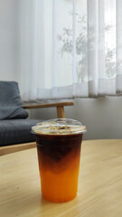Beverage - Ice Espresso orange is iced black coffee with orange juice on the table at coffee cafe 