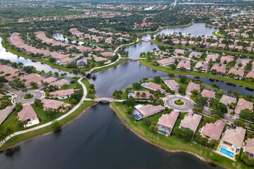 A view of a neighborhood with a river in the foreground and a row of houses.