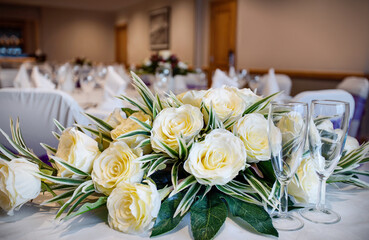 Floral arrangement of white roses for the top table at a wedding ceremony