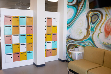 Bright and colourful wall of lockers in foyer of coworking space
