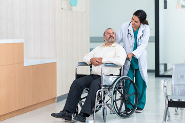 Fototapeta na wymiar Young woman doctor with senior man sitting on wheelchair in hospital. female doctor assist take care of smiling old man. elderly healthcare concept.