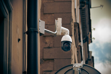 city surveillance camera placed on an old tenement house