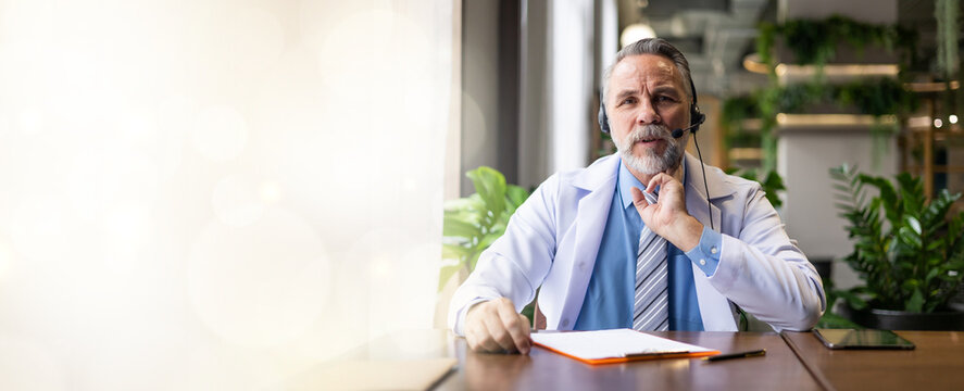 Looking at camera. Senior caucasian doctor online video call conference consult patient on laptop computer. Doctor online consultation and telehealth medicine