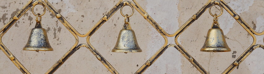 Three Rustic Cowbells. Iron Decorative Hanging Bells with tarnished brass finish. Home design.