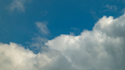 Naklejka na ściany i meble Cloudy sky. Clouds and blue sky. Blue sky and white clouds close-up