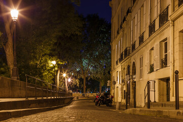 Fototapeta na wymiar Night street view in Paris, France, Europe. Old architecture