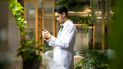 Doctor online consultation and telehealth medicine. Healthcare worker physician in white coat use smartphone at medical and wellness hospital center