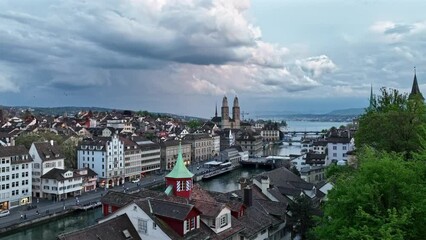 Aerial view over City of Zürich with church towers and medieval old town on a cloudy spring evening. Movie shot May 6th, 2023, Zurich, Switzerland.