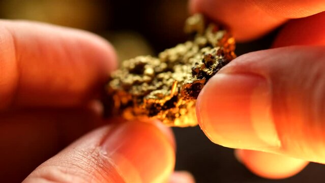 The lump of gold found in the mine was in the hands of a man.