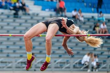 close-up girl jumper high jump in summer athletics championships