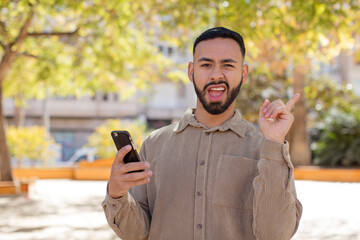 young  adult man feeling like a happy and excited genius after realizing an idea. using a...