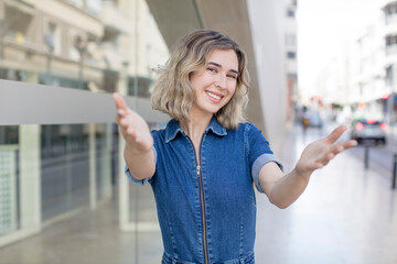 pretty woman smiling cheerfully giving a warm, friendly, loving welcome hug, feeling happy and adorable