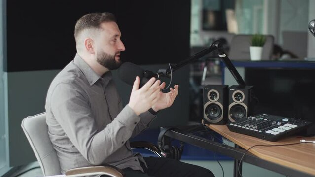 Portrait of happy young man working as radio host at radio station.