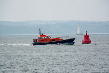 Fototapeta premium A pilot Boat at see guiding a ship into port