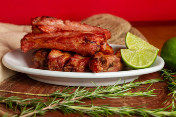 Roasted pork ribs served with lemon wedges
