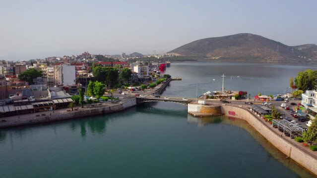 4k drone forward video (Ultra High Definition) of Chalcis town with Chalkida's Old Bridge, Greece, Europe. Spectacular morning on Euboea island, Greece, Europe. Traveling concept background.