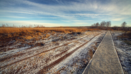 Obraz premium rural landscape with frosted ground and path