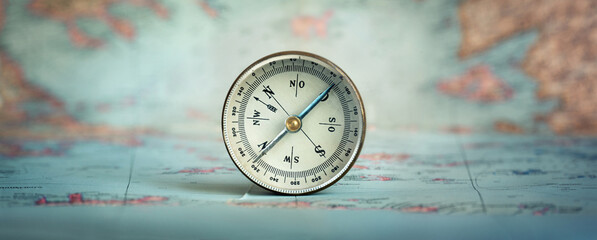 Magnetic old compass on world map.Travel, geography, navigation, tourism and exploration concept background.