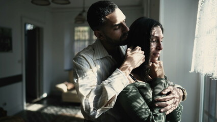 A caring Arab boyfriend comforting his tearful girlfriend by the window during a challenging...
