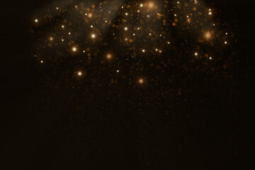 Abstract defocused lights and bokeh on dark background. Gold sparkles and glitter on black background