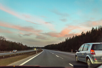 Movement on the evening highway, beautiful sunset sky.