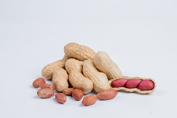 Peeled peanuts and peanut pod isolated on white background.