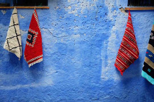 Traditional morocan carpets in Chefchaouen street, the blue city in Morocco old town.