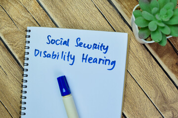 Concept of Social Security Disability Hearing write on book isolated on Wooden Table.