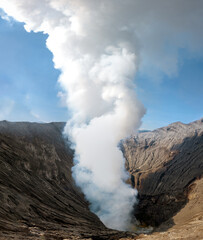 Fototapeta na wymiar Dramatic view inside the crater and active caldera of Mount Bromo (Gunung Bromo) an active somma volcano, Bromo Tengger Semeru National Park, East Java, Indonesia.