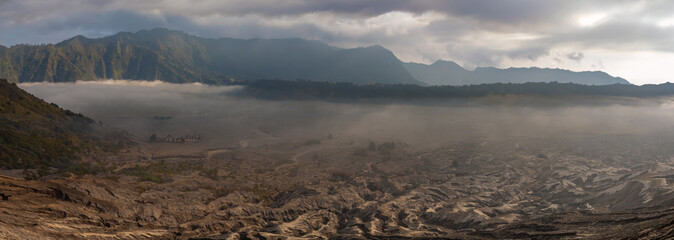 Panoramic view of the Sea of Sand (Segara Wedi) from the edge of Mount Bromo's crater (Gunung...