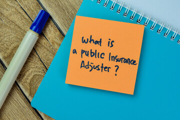 Concept of What is a Public Insurance Adjuster? write on sticky notes isolated on Wooden Table.