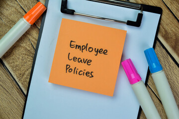 Concept of Employee Leave Policies write on sticky notes isolated on Wooden Table.