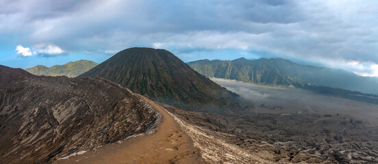 Hiking trail along the edge of Mount Bromo's crater with Mount Semeru, Mount Batok and the Sea of...