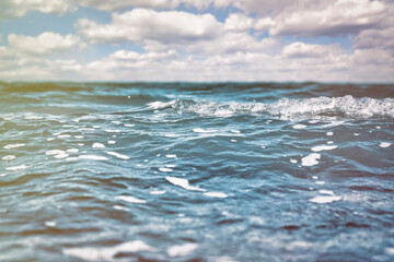 Fototapeta premium Sea surface with small waves and cloudy sky on the horizon.