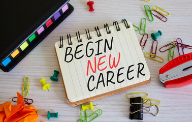 Begin new career symbol. Concept word Begin new career on white notebook. Beautiful wooden...