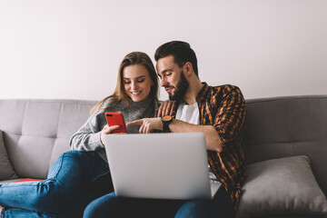 Cheerful couple browsing phone together