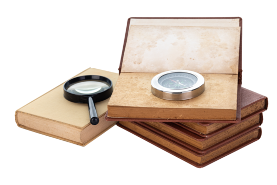 Compass and magnifying glass on old books.