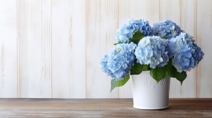 Blue hydrangeas flowers in the white vase on the wooden table free copy space