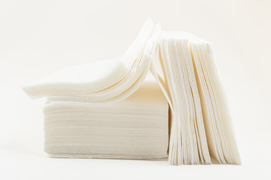 Stack of paper napkins on a white background.
